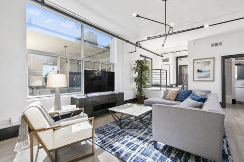 a living room with white walls and hardwood floors
